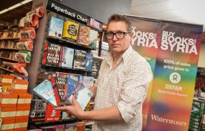  Waterstones manager Matt Harrop with some of the books being sold to raise funds for Syrian refugees