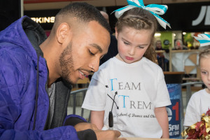 Dolly Westfall, six, of Team XTreeme, collects her signed photo from Josh Daniel